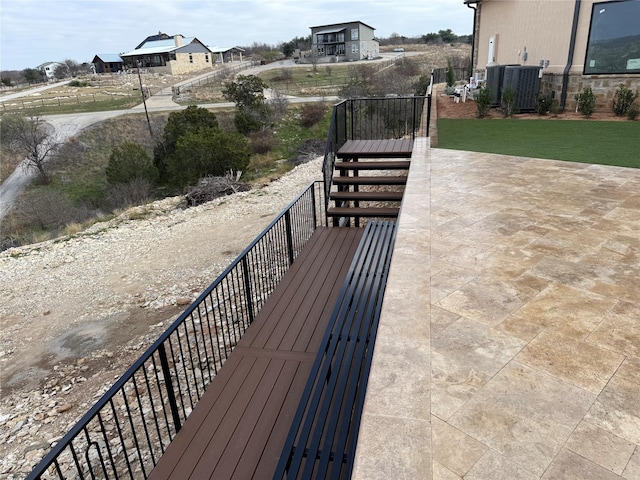 wooden deck with central AC unit and stairs