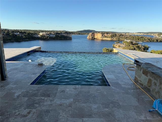 view of pool featuring a water view