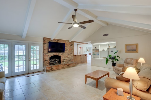 tiled living room featuring ceiling fan, french doors, beamed ceiling, a brick fireplace, and brick wall