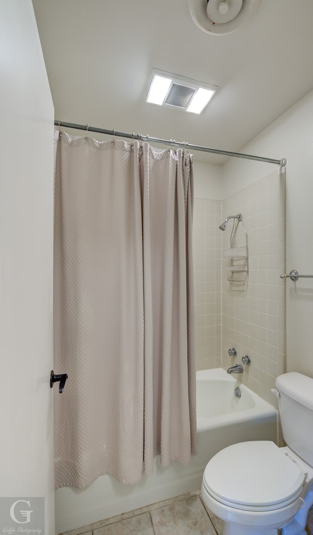 bathroom with toilet, tile floors, and shower / tub combo with curtain