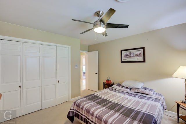 carpeted bedroom with a closet and ceiling fan