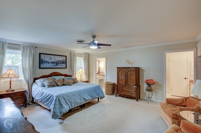 bedroom with light colored carpet, ensuite bathroom, ceiling fan, and multiple windows