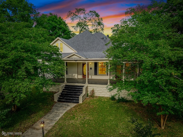 view of front of property featuring a lawn and a porch