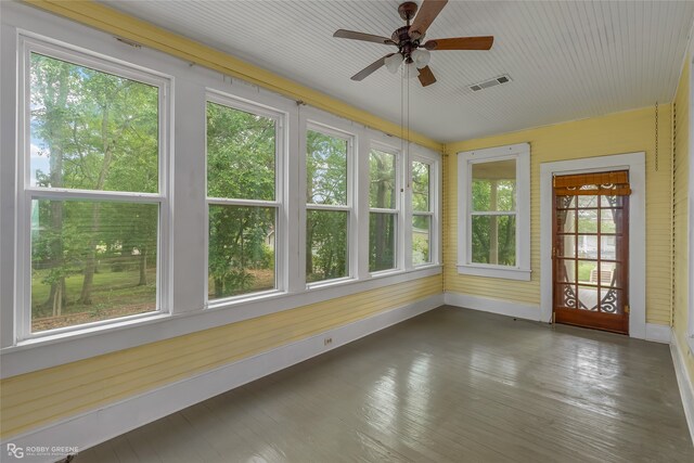 unfurnished sunroom featuring ceiling fan