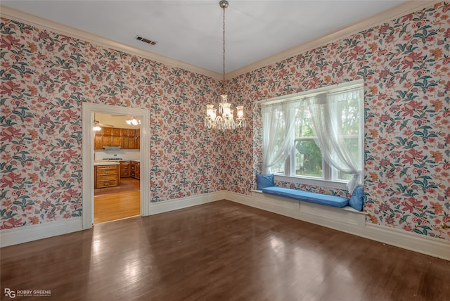 unfurnished dining area featuring ornamental molding, a chandelier, and dark wood-type flooring