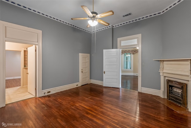 unfurnished living room with wood-type flooring, ceiling fan, and crown molding