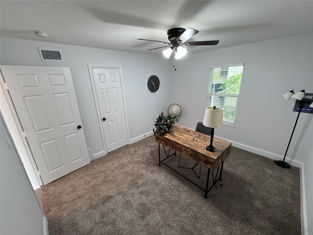 carpeted office space featuring ceiling fan