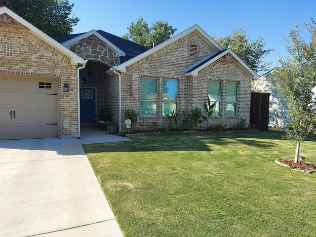 view of front of house with a front yard and a garage