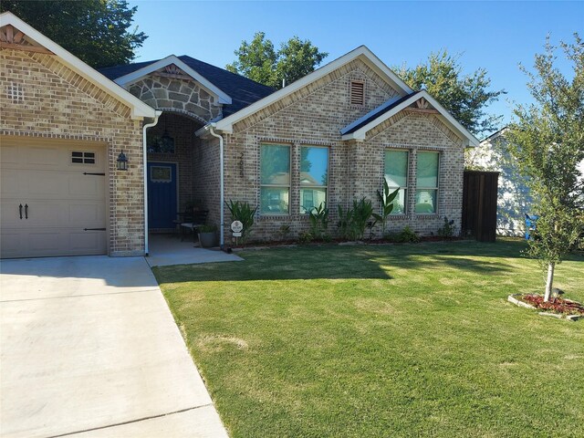 view of front of house with a garage and a lawn