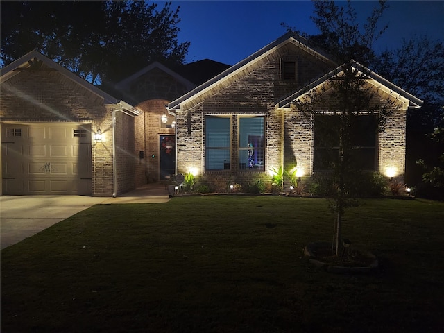 view of front of house with a yard and a garage