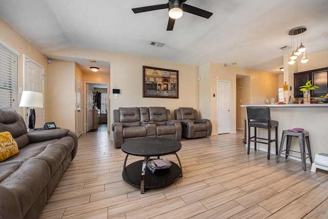 living room featuring ceiling fan and light hardwood / wood-style floors