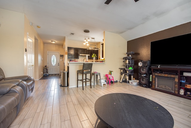 living room with ceiling fan and light hardwood / wood-style flooring