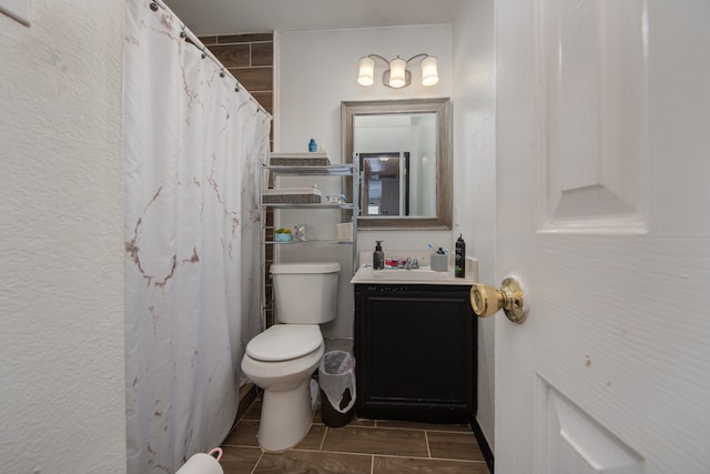 bathroom with vanity, toilet, and tile floors