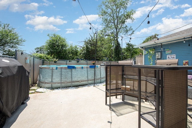 view of terrace with a fenced in pool