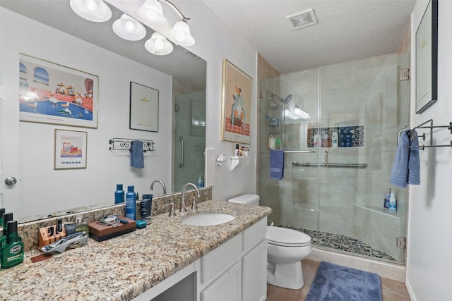 bathroom featuring an enclosed shower, toilet, a textured ceiling, and tile patterned floors