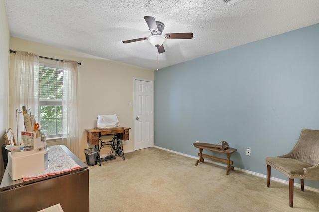 carpeted office space featuring ceiling fan and a textured ceiling