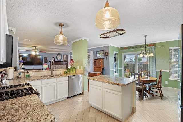 kitchen with dishwasher, decorative light fixtures, white cabinetry, and sink