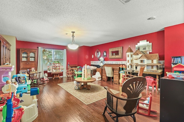 interior space featuring dark hardwood / wood-style flooring and a textured ceiling