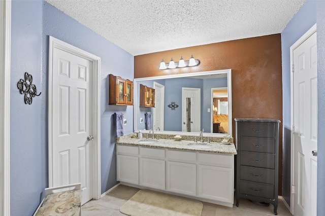 bathroom with vanity and a textured ceiling