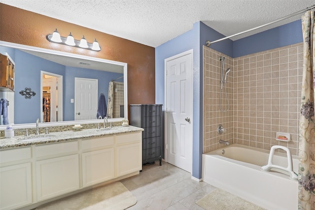 bathroom featuring shower / bathtub combination with curtain, tile patterned flooring, vanity, and a textured ceiling