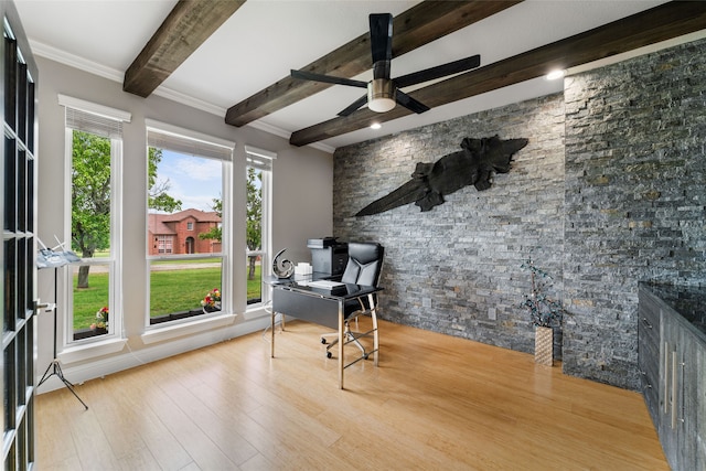 home office with beamed ceiling, a healthy amount of sunlight, ceiling fan, and light hardwood / wood-style flooring