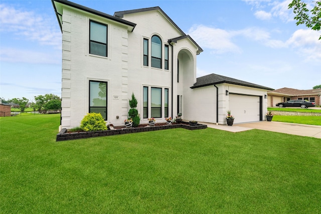 view of front of home featuring a front yard and a garage