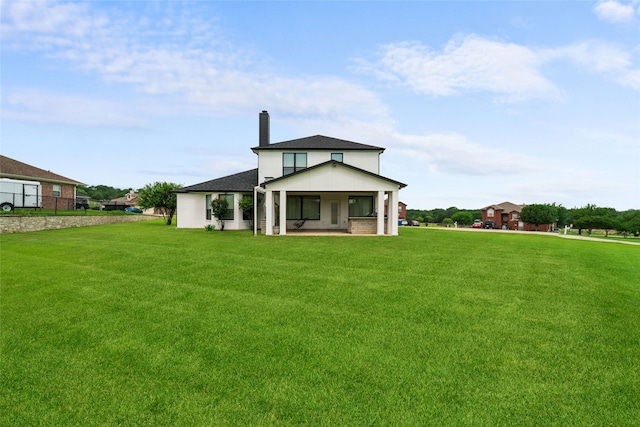 rear view of property with a patio area and a yard