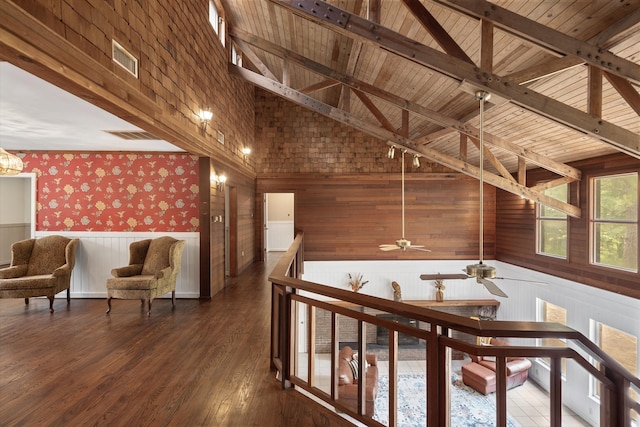 corridor with dark hardwood / wood-style flooring, high vaulted ceiling, beam ceiling, and wooden ceiling