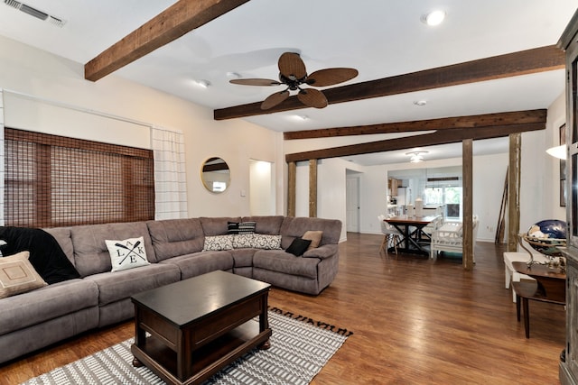 living room with beamed ceiling, dark hardwood / wood-style floors, and ceiling fan