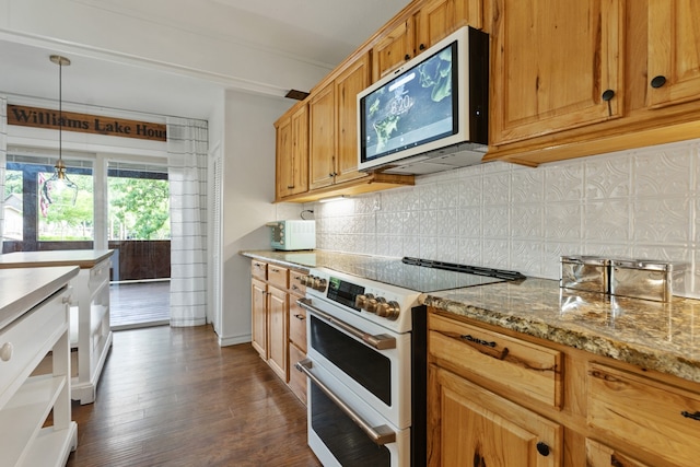 kitchen featuring light stone countertops, dark wood-type flooring, tasteful backsplash, decorative light fixtures, and high end range