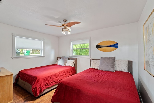 bedroom with hardwood / wood-style floors and ceiling fan