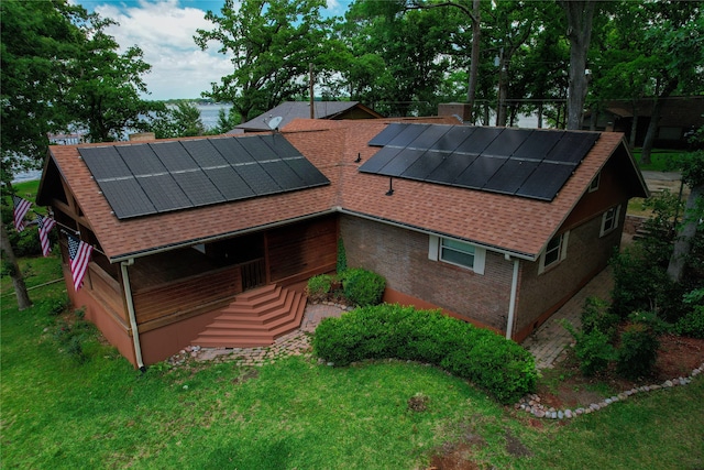 rear view of property with solar panels