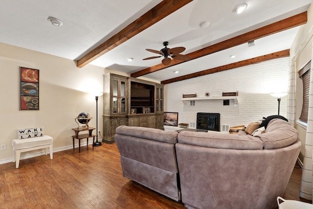 living room with beam ceiling, ceiling fan, brick wall, and hardwood / wood-style flooring