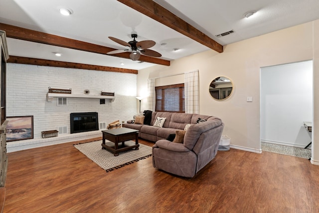 living room with a fireplace, ceiling fan, hardwood / wood-style floors, and brick wall