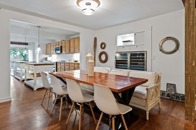 dining space featuring dark wood-type flooring and wine cooler