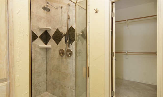 bathroom featuring a shower with shower door