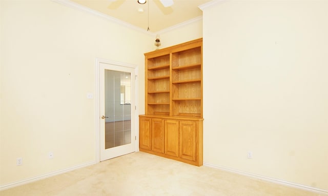 carpeted empty room featuring crown molding, french doors, and ceiling fan