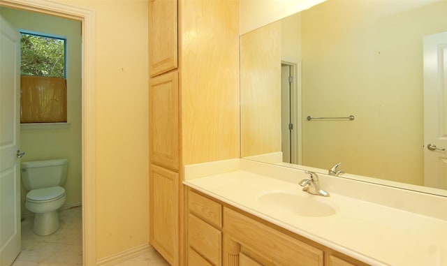 bathroom featuring tile patterned flooring, vanity, and toilet