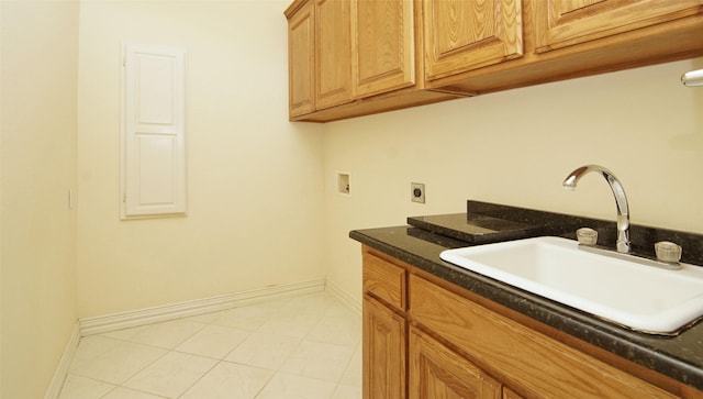 clothes washing area with hookup for a washing machine, sink, cabinets, and hookup for an electric dryer