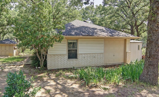 view of property exterior with a shed and a garage