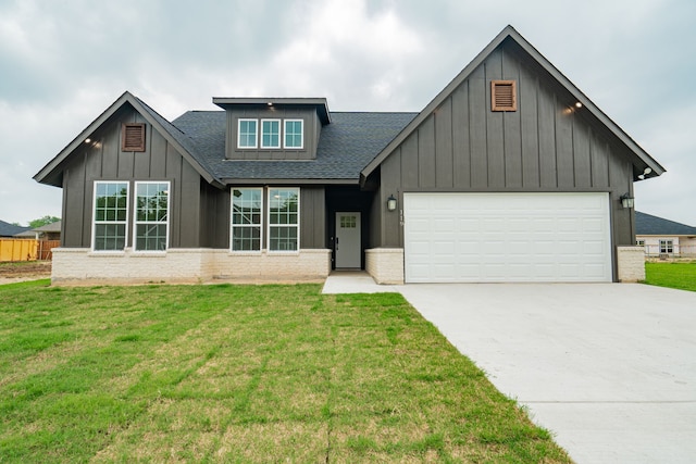 view of front facade with a garage and a front lawn