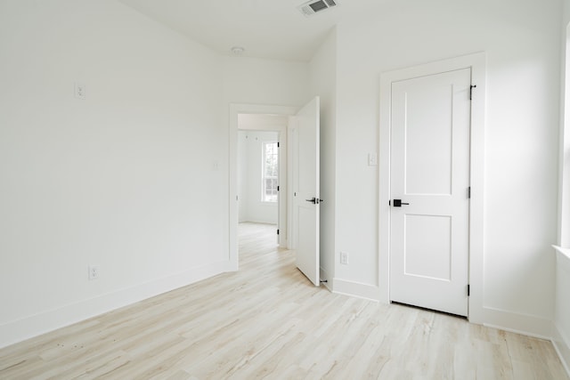 empty room with light hardwood / wood-style flooring