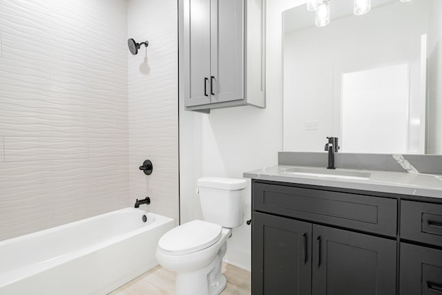 full bathroom with tiled shower / bath, toilet, and large vanity