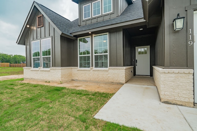 doorway to property with a lawn