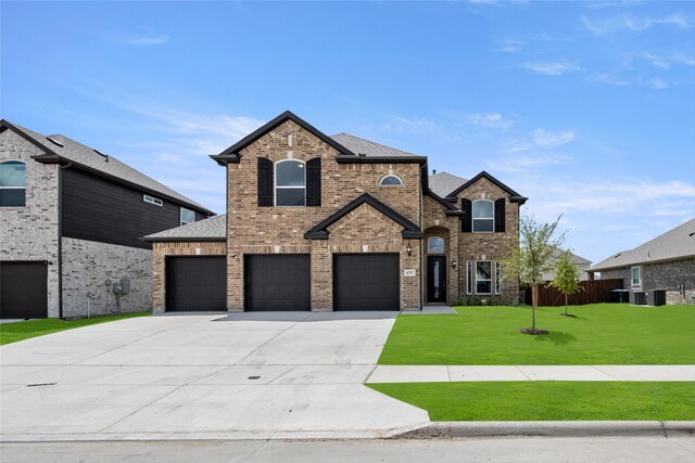 view of front of home featuring a garage and a front lawn