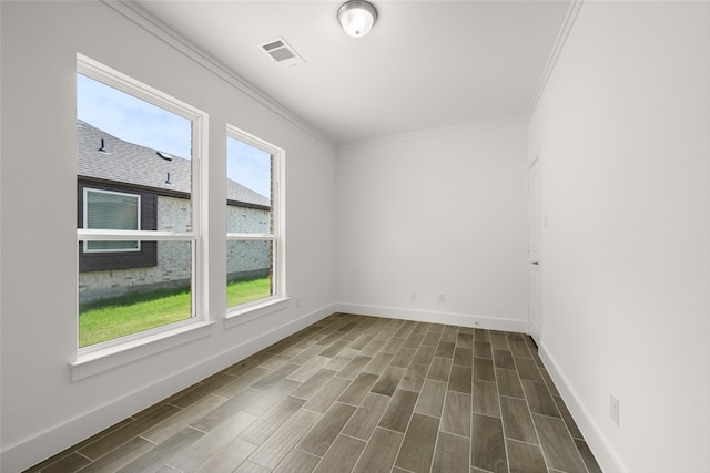 empty room featuring hardwood / wood-style floors and ornamental molding