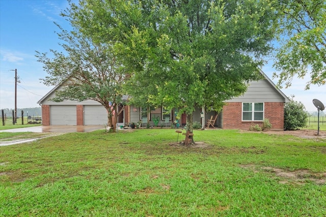 view of property hidden behind natural elements featuring a garage and a front lawn