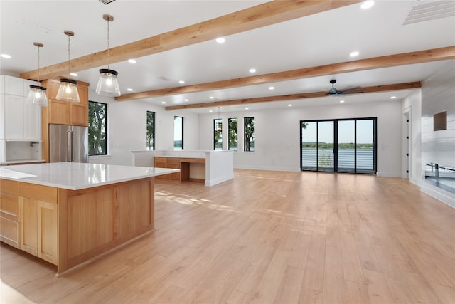 kitchen featuring a large island, light hardwood / wood-style floors, decorative light fixtures, and high end fridge