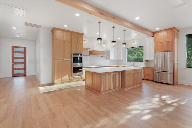 kitchen featuring light hardwood / wood-style flooring, stainless steel appliances, beam ceiling, and a kitchen island