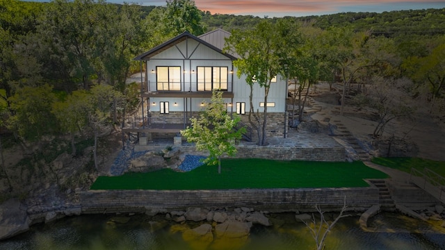 view of back house at dusk